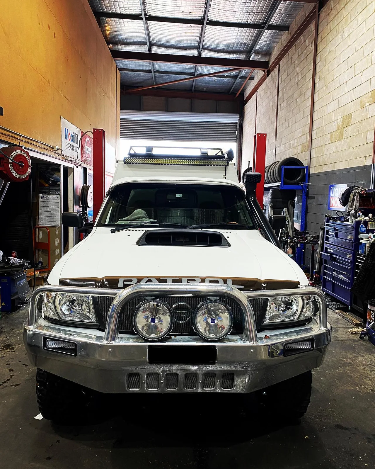 White Nissan Patrol inside the workshop